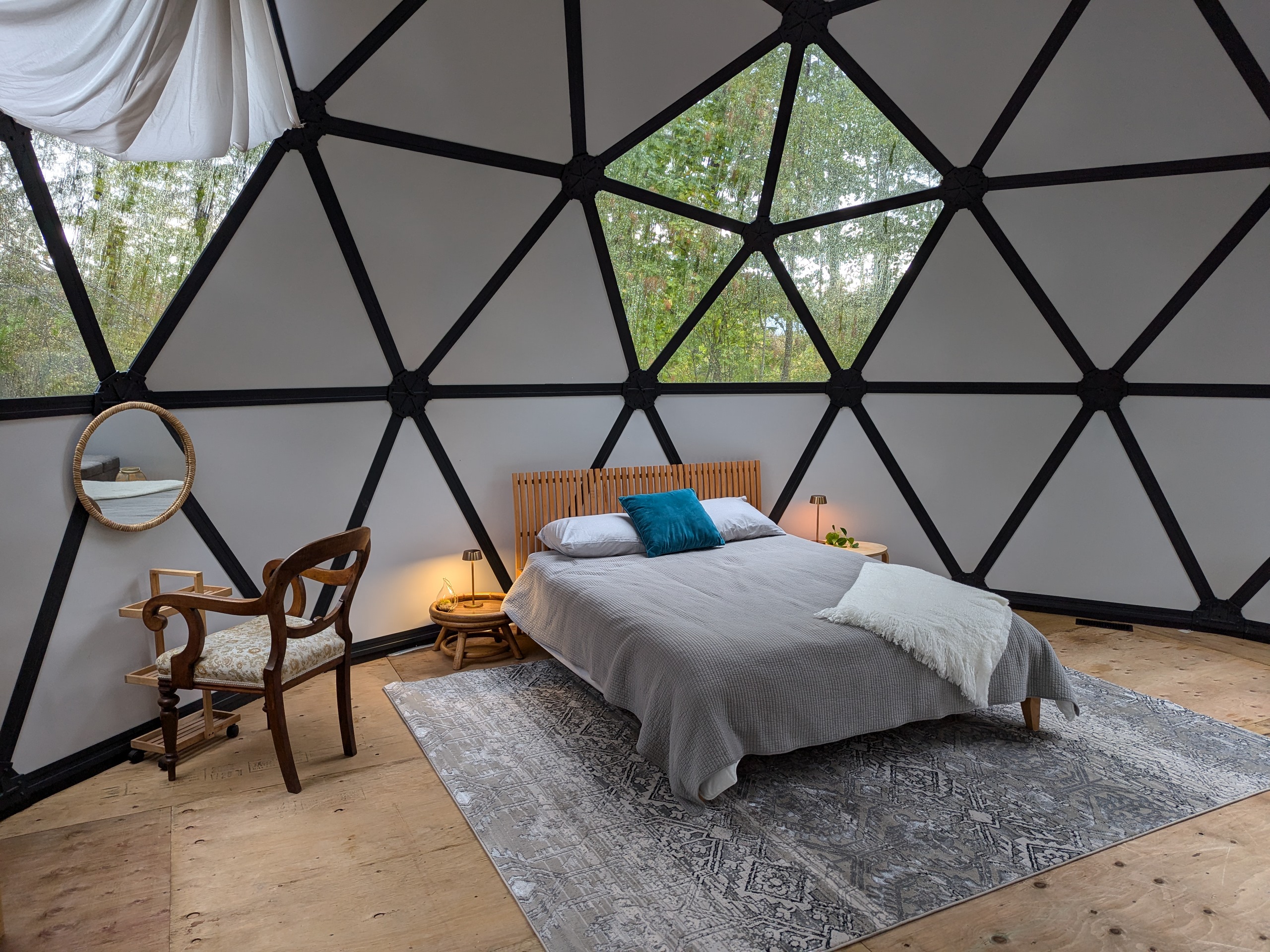 Queen sized bed in dome with rug